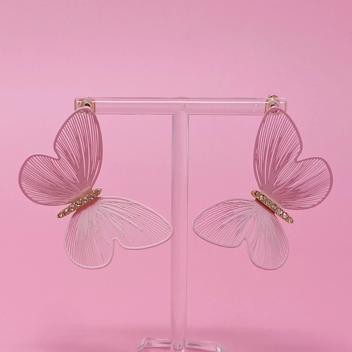 Filigree Beauty Butterfly Earrings with intricate design on a jewelry stand