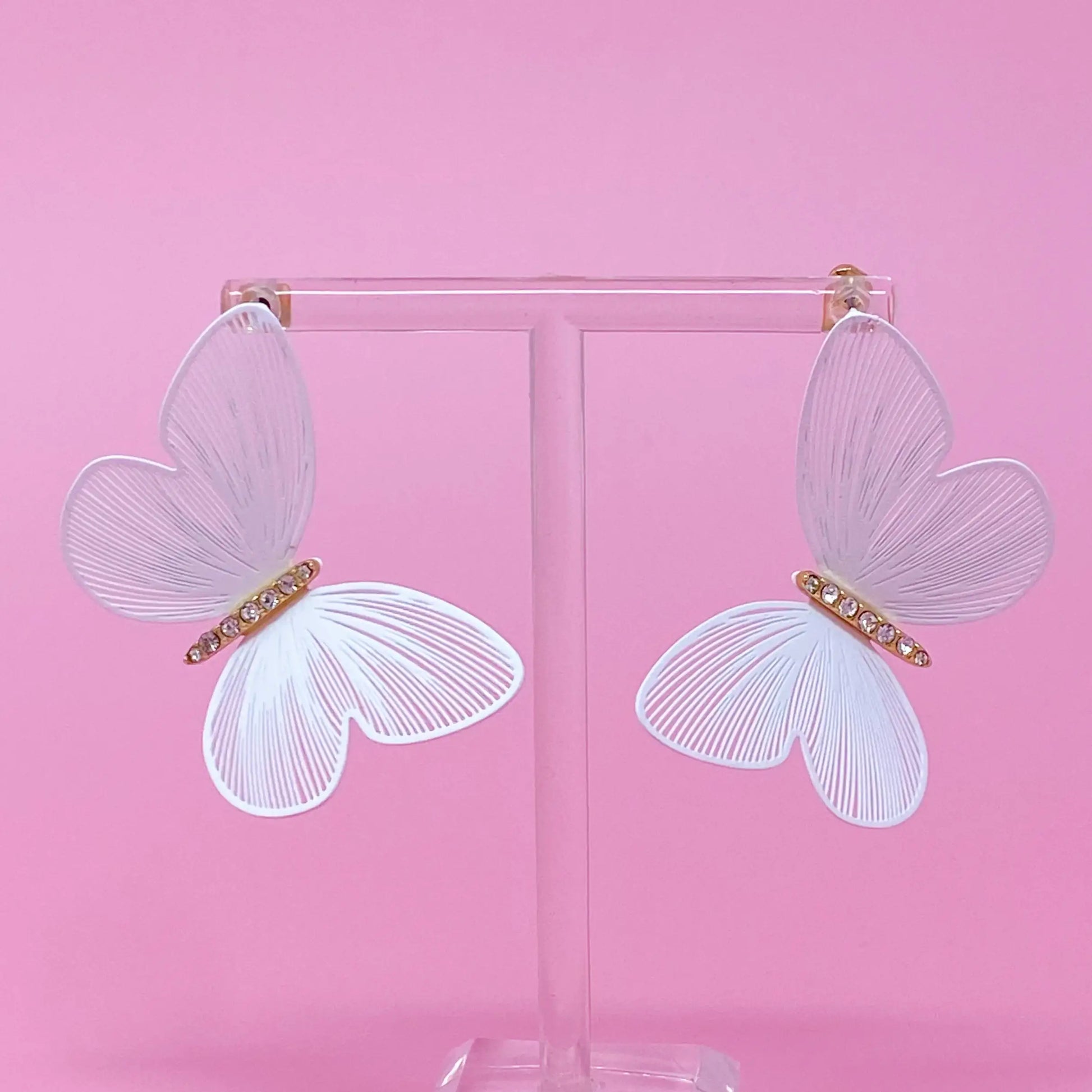 Filigree Beauty Butterfly Earrings with intricate design on a jewelry stand